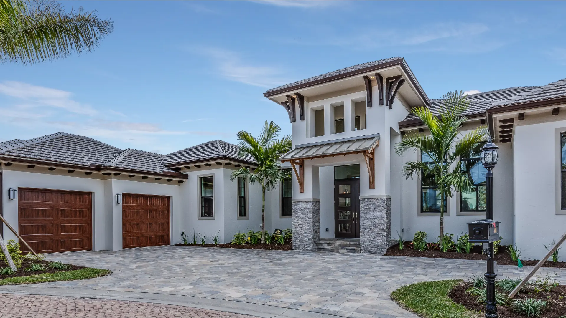 A high net worth-insured luxury home, framed by lush palm trees and featuring an impeccably designed brick driveway, epitomizing elegance. A high net worth-insured luxury home, framed by lush palm trees and featuring an impeccably designed brick driveway, epitomizing elegance.